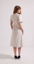 Woman wearing a beige dress on a white background