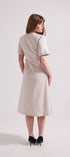 Woman wearing a beige dress on a white background