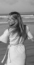 Woman standing on a beach with long hair flowing, black and white photo