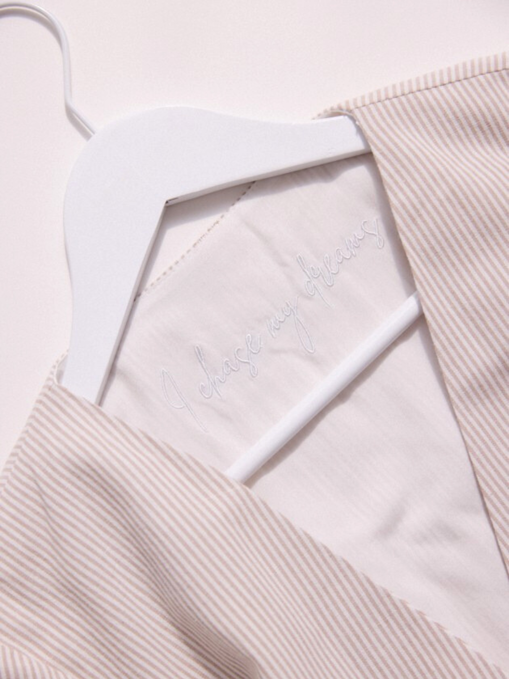 Light pink textured fabric with a white label on a light pink background