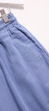 Blue pants with text embroidery on a white background