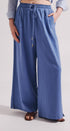 Person wearing blue wide-leg pants on a plain background