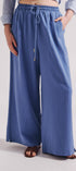 Person wearing blue wide-leg pants on a plain background