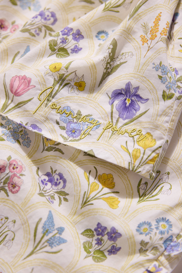 Floral patterned fabric with 'Everyday Power' text on a white background