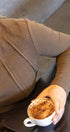 Person holding a cup of coffee in a casual setting
