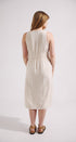Woman wearing a white sleeveless dress against a plain background