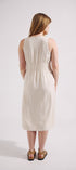 Woman wearing a white sleeveless dress against a plain background