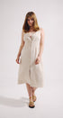 Woman wearing a white dress on a plain background