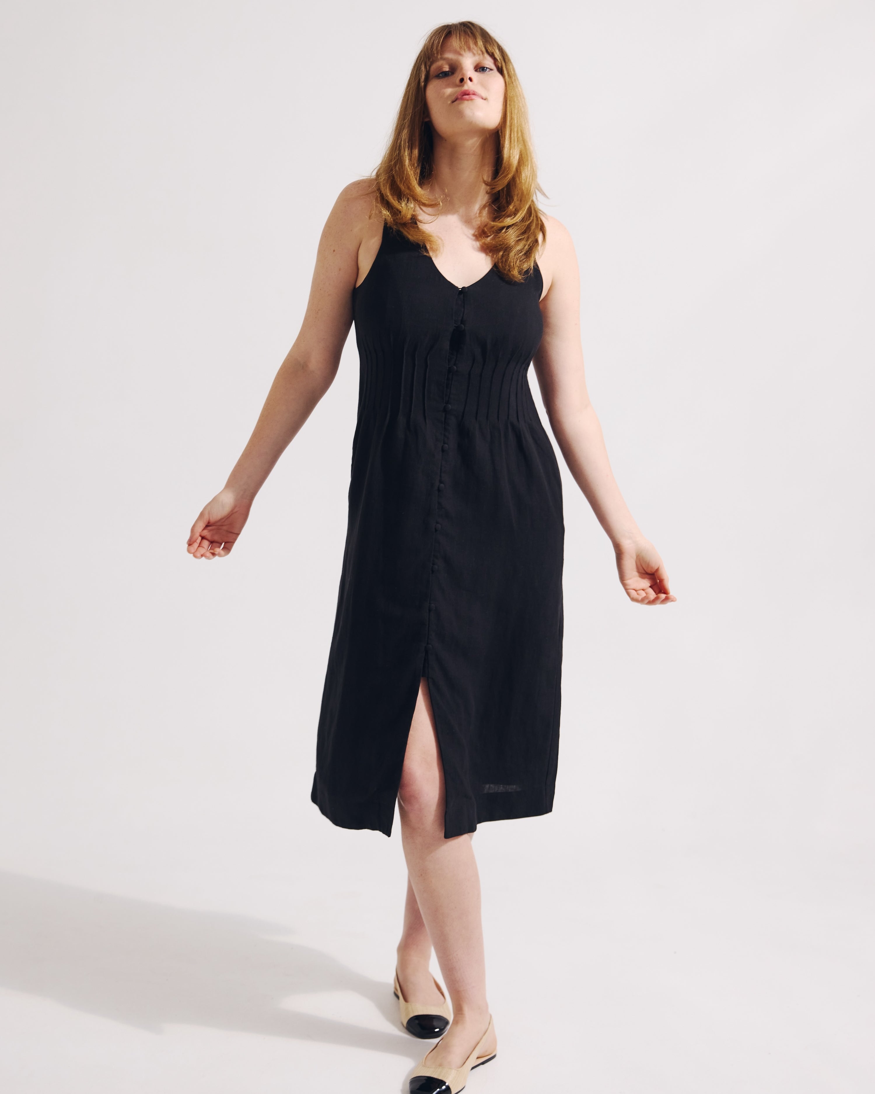 Woman wearing a black dress on a white background