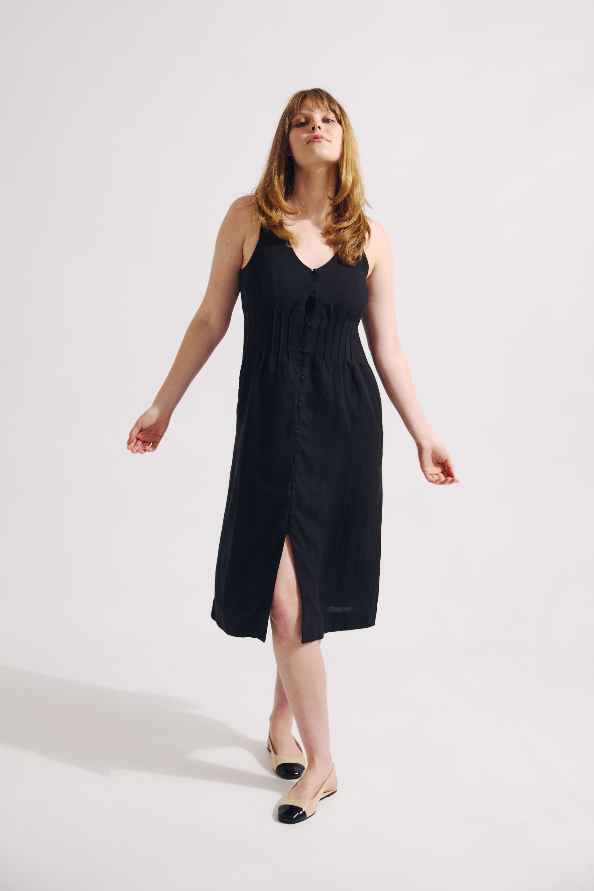 Woman wearing a black dress on a white background