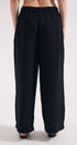 Black wide-leg pants worn by a person on a white background