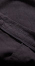 Dark fabric with embroidered text on a black background
