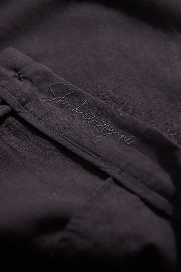 Dark fabric with embroidered text on a black background