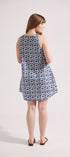 Woman wearing a sleeveless patterned dress on a white background
