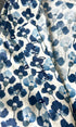 Fabric with blue floral pattern on a white background