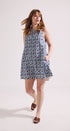 Woman wearing a patterned dress on a white background