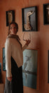 Woman standing in a room with framed animal skeletons on the wall