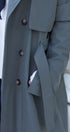 olive coat with buttons on a white background