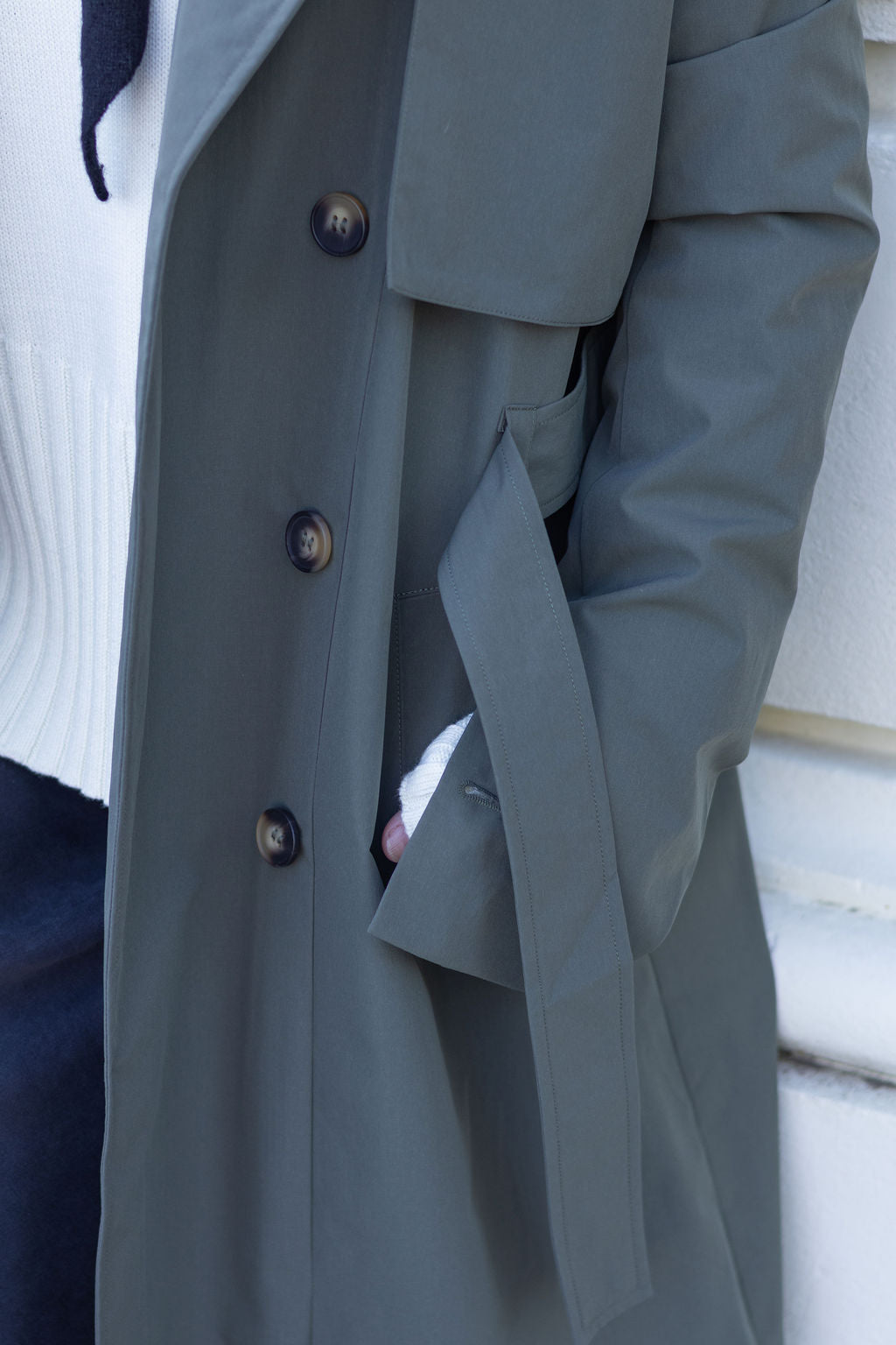 olive coat with buttons on a white background