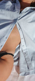 Close-up of a person wearing a striped shirt with a blurred background
