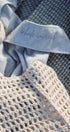 Textured fabric with a mesh bag and autumn leaves