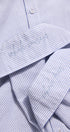 Close-up of a blue and white striped shirt with embroidery on the collar.