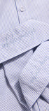 Close-up of a blue and white striped shirt with embroidery on the collar.