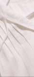 Close-up of a white garment with 'Ibreath' embroidery on a light background