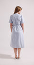 Woman wearing a light blue dress on a white background
