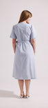 Woman wearing a light blue dress on a white background
