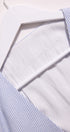 Close-up of a white shirt with blue striped collar and cuffs.