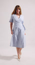 Woman wearing a light blue dress on a white background