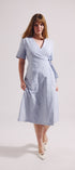 Woman wearing a light blue dress on a white background