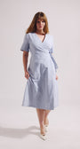 Woman wearing a light blue dress on a white background