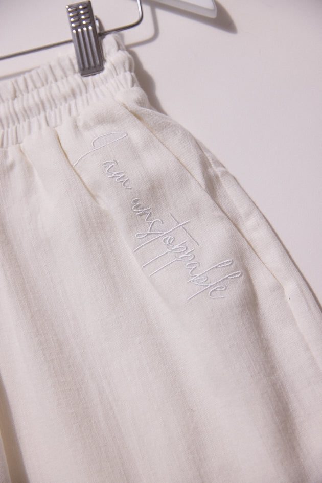 White sweatpants with text on a white background
