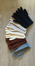 Set of colorful gloves arranged on a wooden surface