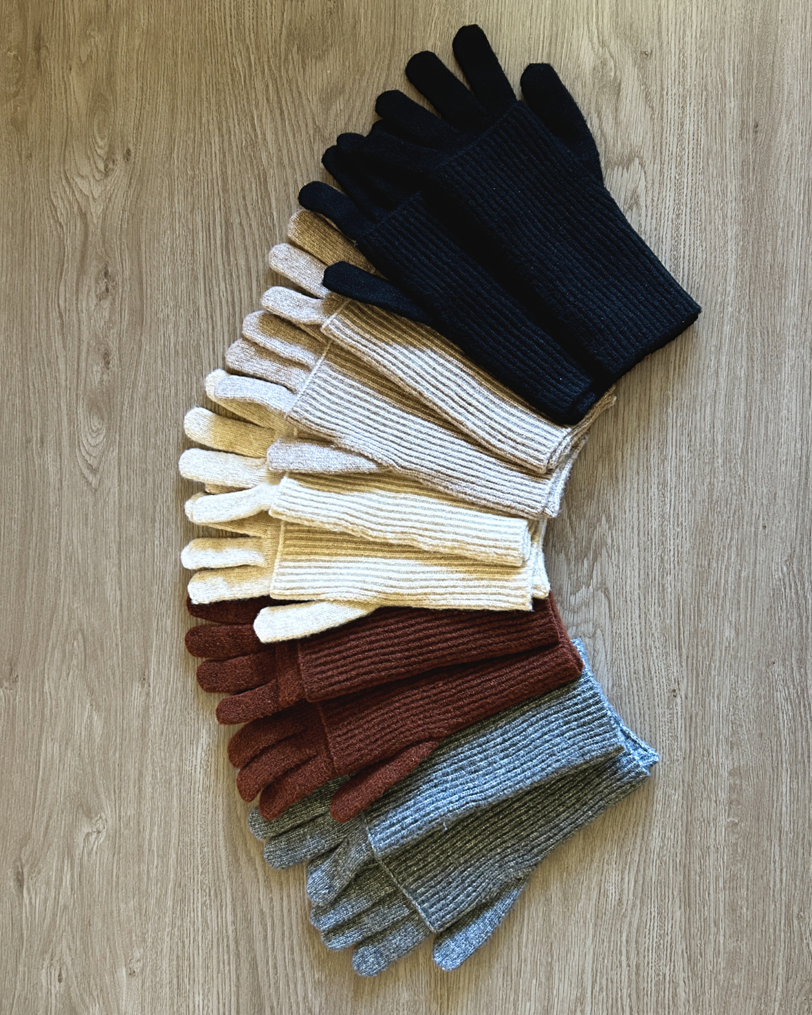 Set of colorful gloves arranged on a wooden surface