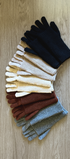 Set of colorful gloves arranged on a wooden surface