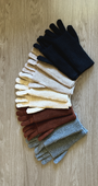 Set of colorful gloves arranged on a wooden surface
