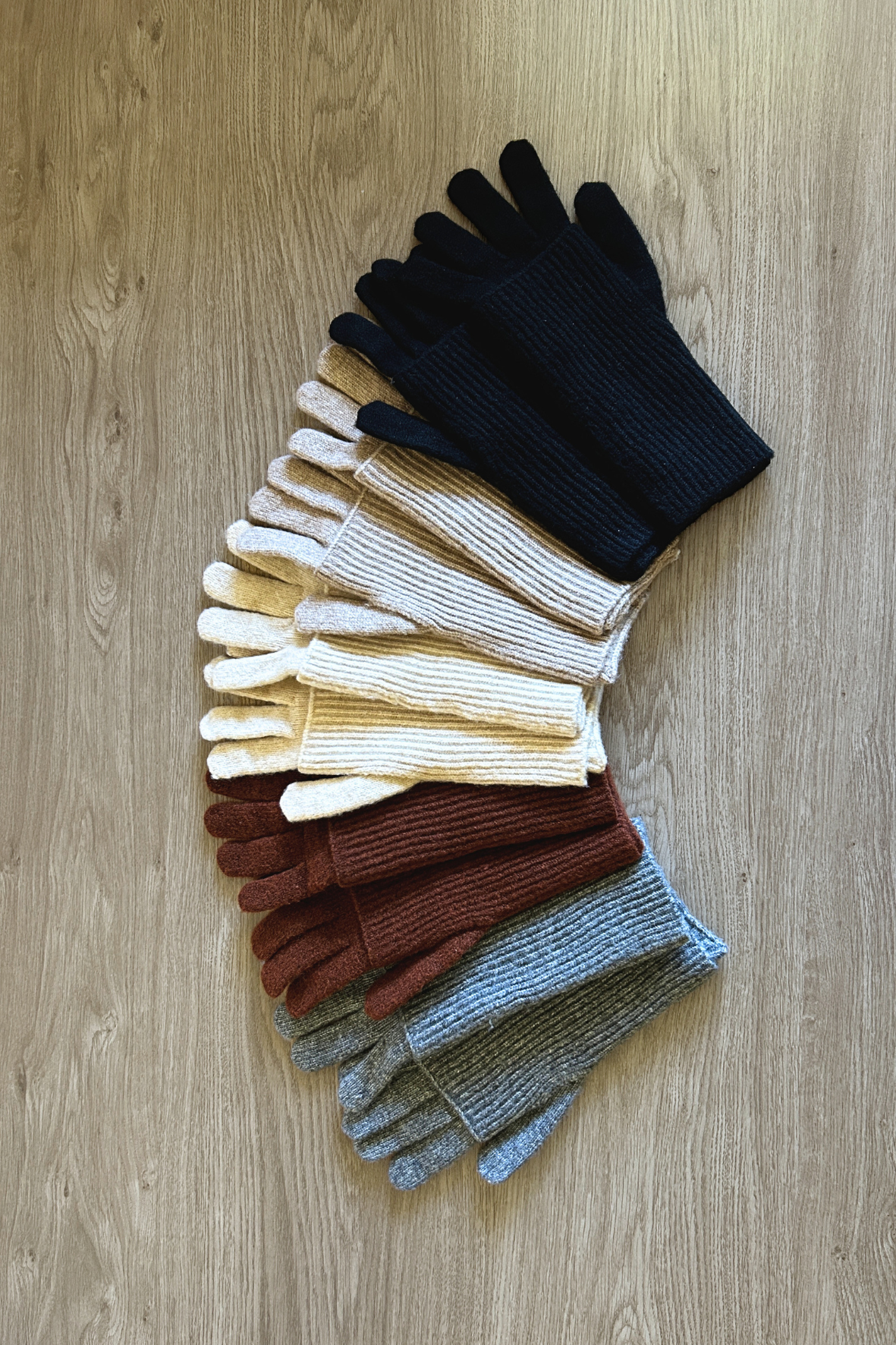 Set of colorful gloves arranged on a wooden surface