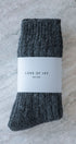 Gray socks with a white label on a textured surface