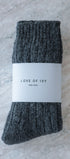 Gray socks with a white label on a textured surface
