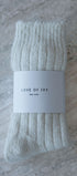 cream sock with 'Love of Ivy' label on a textured surface