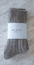 light brown socks with a 'Love of Ivy' label on a textured surface