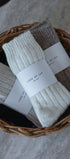 Three pairs of socks in a wicker basket with 'Love of Ivy' labels.